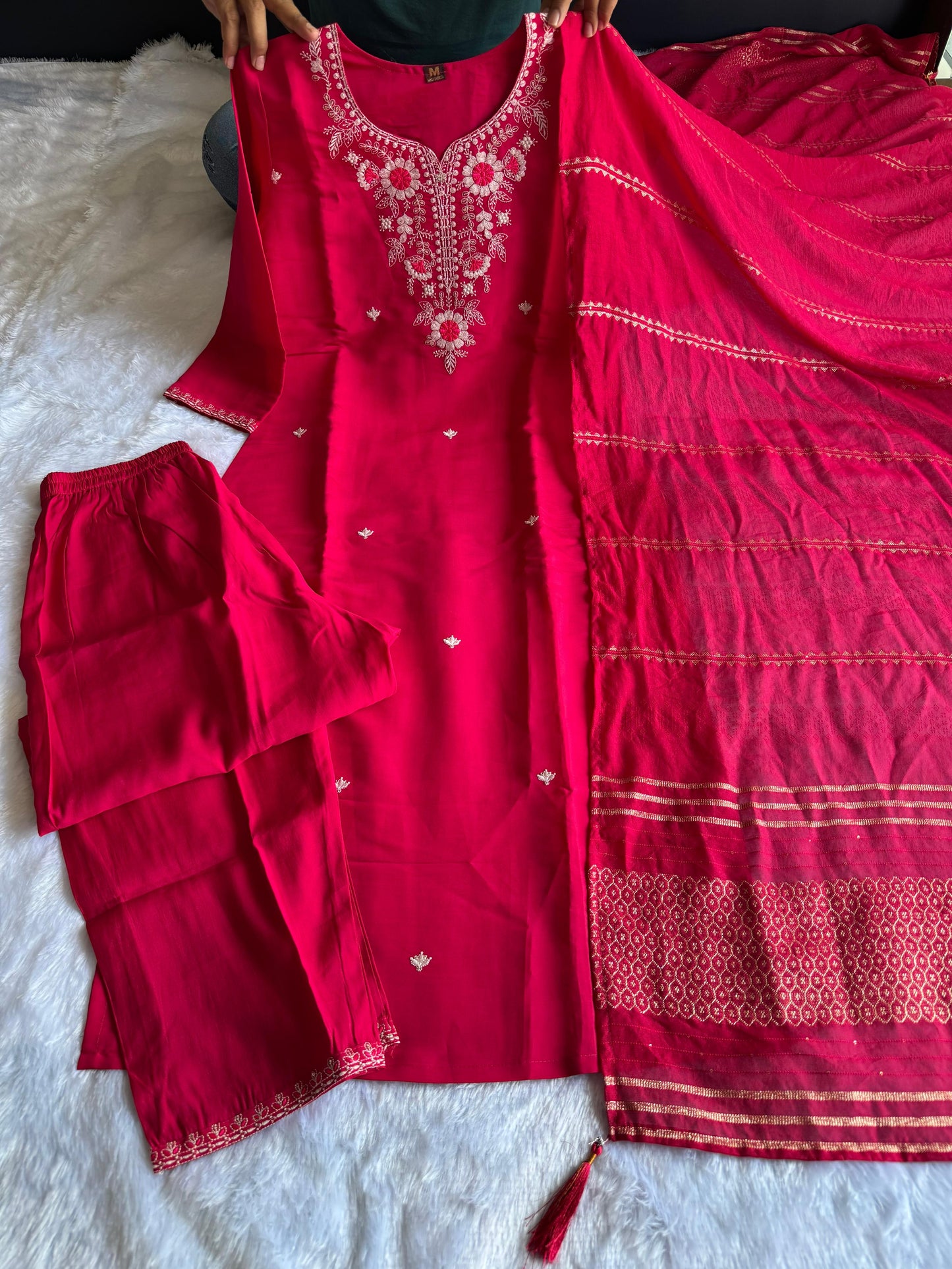 Intricate embroidery with sequins adds festive sparkle